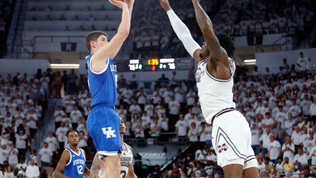 Feb 27, 2024; Starkville, Mississippi, USA; Kentucky Wildcats guard Reed Sheppard (15) shoots as Mississippi State Bulldogs forward Cameron Matthews (4) defends during the second half at Humphrey Coliseum. Mandatory Credit: Petre Thomas-USA TODAY Sports