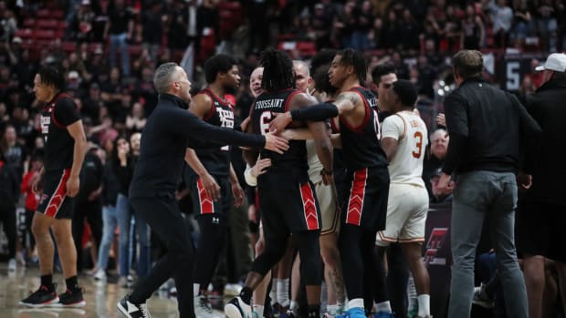 Texas and Texas Tech men’s basketball players have to be separated after a hard foul during a game in Lubbock.
