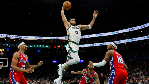Boston Celtics forward Jayson Tatum (0) goes in for a dunk as Philadelphia 76ers forward Darius Bazley (25) and guard Ricky Council IV (16) look on during the second half at TD Garden in Boston, Massachusetts, on Feb. 27, 2024.