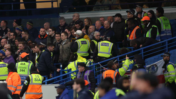 Stewards, police officers and medical staff pictured in the away end at Chelsea's Stamford Bridge after a Leeds United fan fell from the upper tier during an FA Cup game in February 2024