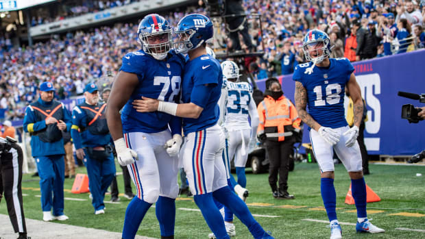 Jan 1, 2023; East Rutherford, New Jersey, USA; New York Giants quarterback Daniel Jones (8) celebrates with New York Giants offensive tackle Andrew Thomas (78) after rushing for a touchdown against the Indianapolis Colts during the second half at MetLife Stadium.