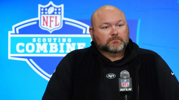 Jets GM Joe Douglas stands at a microphone