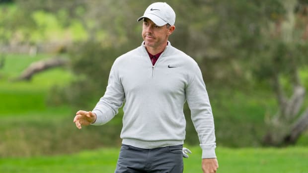 Rory McIlroy acknowledges the crowd after making his putt on the second hole during the third round of the AT&T Pebble Beach Pro-Am golf tournament at Pebble Beach Golf Links. 