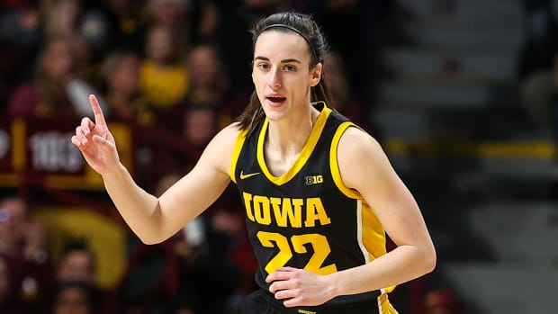 Iowa guard Caitlin Clark reacts to shooting a three-point basket.