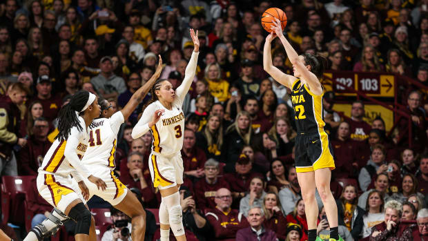 Iowa guard Caitlin Clark (22) shoots as Minnesota guard Amaya Battle (3) defends during the first half at Williams Arena in Minneapolis on Feb. 28, 2024.