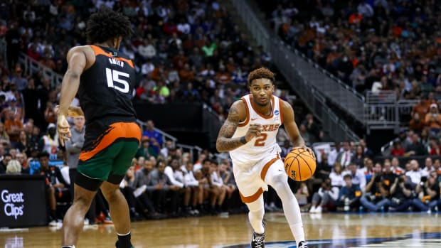 Mar 26, 2023; Kansas City, MO, USA; Miami Hurricanes forward Norchad Omier (15) defends as Texas Longhorns guard Arterio Morris (2) dribbles the ball in the second half at the T-Mobile Center.