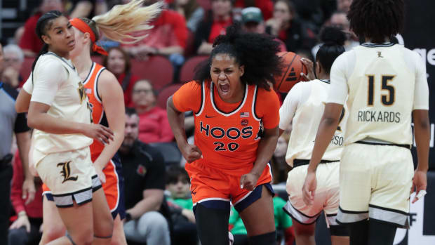 Camryn Taylor reacts after scoring a basket during the Virginia women's basketball game at Louisville at the KFC Yum! Center.