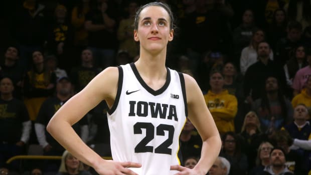 Iowa Caitlin Clark (22) reacts as a video highlighting her career plays in honor of her breaking the NCAA all-time scoring record Thursday, Feb. 15, 2024 at Carver-Hawkeye Arena in Iowa City, Iowa.