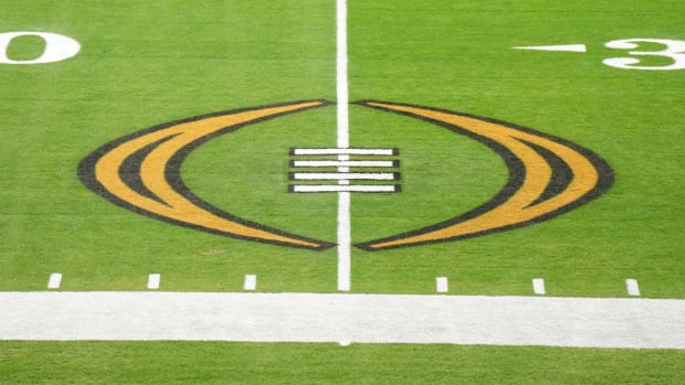 The College Football Playoff logo on the field at State Farm Stadium, the site of the 2022 CFP Semifinal between the TCU Horned Frogs and the Michigan Wolverines and Super Bowl 57 (LVII)