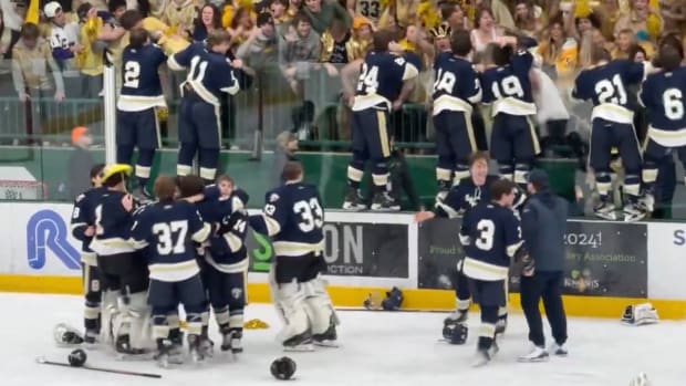 Chanhassen celebrates an upset win over Minnetonka in the section final at Braemar Arena in Edina on Feb. 29, 2024.