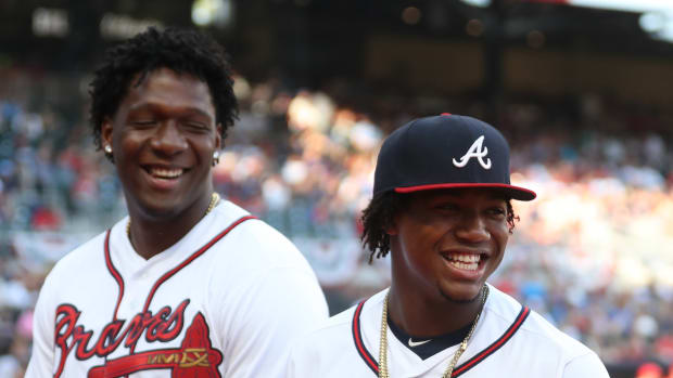 Jul 2, 2019; Atlanta, GA, USA; Atlanta Braves center fielder Ronald Acuna Jr. (13) is accompanied by his brother Luisangel Acuna as he receives his All-Star jersey before a game against the Philadelphia Phillies at SunTrust Park.