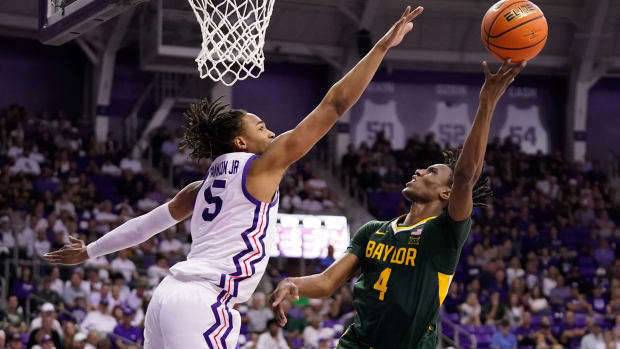 Baylor Bears guard Ja'Kobe Walter (4) shoots over TCU Horned Frogs forward Chuck O'Bannon Jr. (5) during the second half at Ed and Rae Schollmaier Arena.