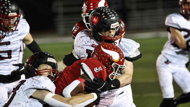 Princeton running back Antonio Hunter (3) is tackled by Lakota West defenders Grant Beerman (33) and Jacob Asbeck (11) during the Firebirds' 19-7 win Friday, Nov. 10, 2023.