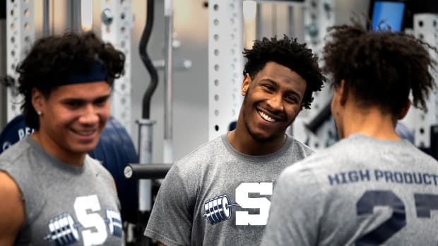 Penn State linebackers Tony Rojas (left) and Kaveion Keys talk with teammate Lamont Payne Jr. during a workout at the Lasch Football Building in State College.