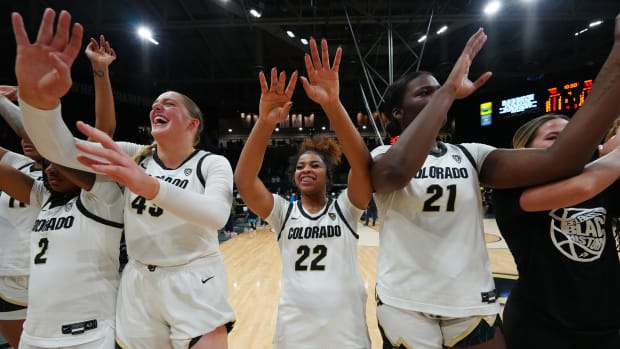Colorado Buffaloes guard Tameiya Sadler (2) and forward Charlotte Whittaker (45) and guard Shelomi Sanders (22) and center Aaronette Vonleh (21) celebrate defeating the Oregon Ducks at CU Events Center