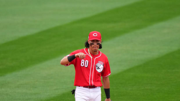Cincinnati Reds shortstop Edwin Arroyo (80) gets set for a pitch in the eighth inning during a MLB spring training baseball game, Monday, Feb. 26, 2024, at Goodyear Ballpark in Goodyear, Ariz.  