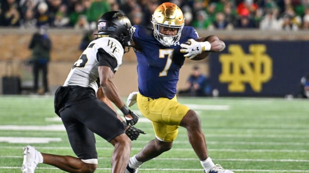 Nov 18, 2023; South Bend, Indiana, USA; Notre Dame Fighting Irish running back Audric Estime (7) runs the ball as Wake Forest Demon Deacons cornerback Jamare Glasker (25) defends in the fourth quarter at Notre Dame Stadium.