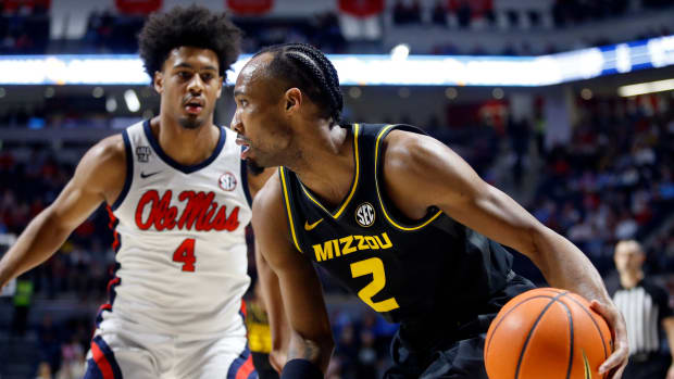 Missouri Tigers guard Tamar Bates (2) dribbles as Mississippi Rebels forward Jaemyn Brakefield (4) defends during the first half at The Sandy and John Black Pavilion at Ole Miss.