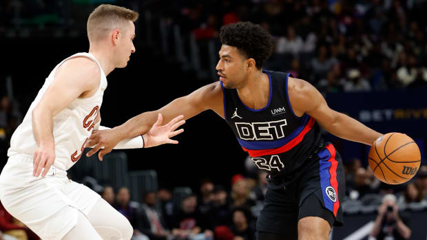 Mar 1, 2024; Detroit, Michigan, USA; Detroit Pistons guard Quentin Grimes (24) dribbles against Cleveland Cavaliers guard Sam Merrill (5) in the first half at Little Caesars Arena.