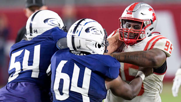 Saraland's Antonio Coleman (95) plays against Clay-Chalkville's Adrian Spivey (64) and Brady Phillips (54) during the AHSAA Class 6A football state championship game at Bryant Denny Stadium in Tuscaloosa, Ala., on Friday December 8, 2023.  