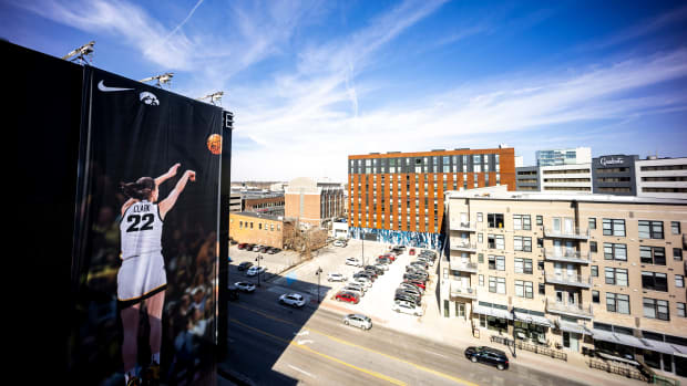 A Nike advertisement featuring a photo of Iowa Hawkeyes women s basketball star Caitlin Clark making a 3-point basket is seen on the side of a 7-story building Saturday, March 2, 2024, in downtown Iowa City. The display is located on the side of The Edge at the corner of Burlington and Clinton Streets. Film crews and fans stopped by for a closer look on Saturday.
