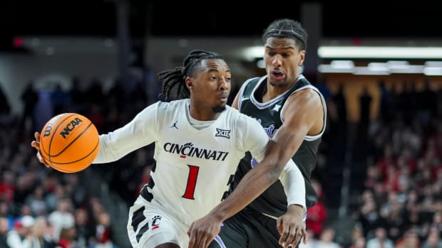 Mar 2, 2024; Cincinnati, Ohio, USA; Cincinnati Bearcats guard Day Day Thomas drives to the basket against Kansas State Wildcats forward David N'Guessan (1) in the first half at Fifth Third Arena. Mandatory Credit: Aaron Doster-USA TODAY Sports
