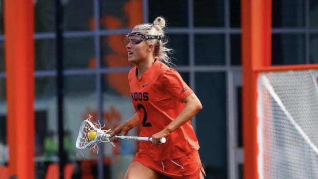 Devon Whitaker clears the ball during the Virginia women's lacrosse game at Clemson.