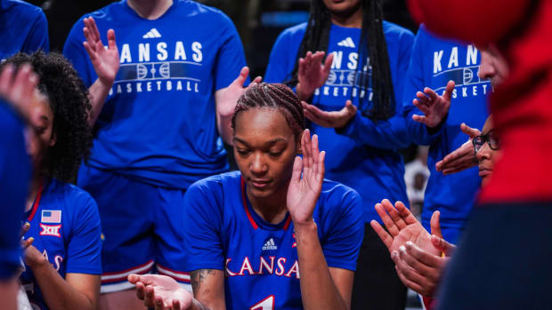 Kansas Center Taiyanna Jackson huddles with her teammates during a timeout of a game against UCF in Orlando.