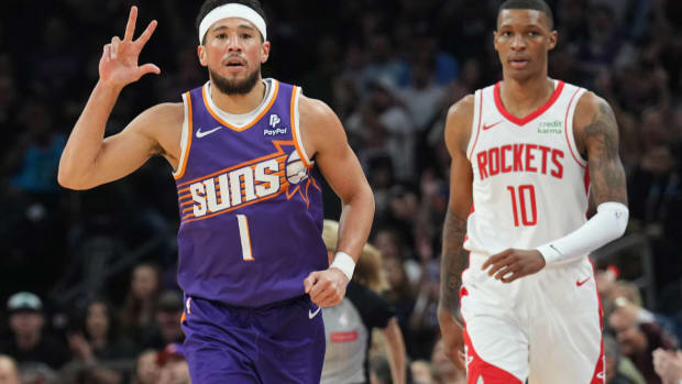 Phoenix Suns guard Devin Booker (1) reacts after making a shot against Houston Rockets forward Jabari Smith Jr. (10) during the first half at Footprint Center.