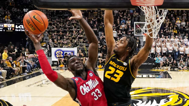 Mississippi Rebels forward Moussa Cisse (33) shoots as Missouri Tigers forward Aidan Shaw (23) defends during the first half at Mizzou Arena.