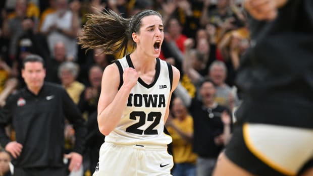 Mar 3, 2024; Iowa City, Iowa, USA; Iowa Hawkeyes guard Caitlin Clark (22) reacts after breaking the NCAA basketball all-time scoring record during the second quarter against the Ohio State Buckeyes.