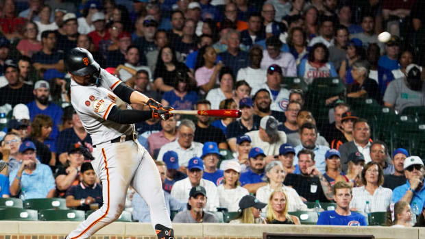 Sep 5, 2023; Chicago, Illinois, USA; San Francisco Giants third baseman J.D. Davis (7) hits a two-run home run against the Chicago Cubs during the sixth inning at Wrigley Field. Mandatory Credit: David Banks-USA TODAY Sports