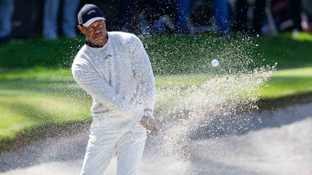 Tiger Woods hits from the sand on the 10th hole during the first round of the 2024 Genesis Invitational.
