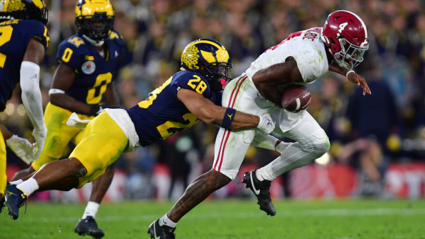 Jan 1, 2024; Pasadena, CA, USA; Michigan Wolverines defensive back Quinten Johnson (28) forces a fumble against Alabama Crimson Tide quarterback Jalen Milroe (4) in the fourth quarter in the 2024 Rose Bowl college football playoff semifinal game at Rose Bowl. Mandatory Credit: Gary A. Vasquez-USA TODAY Sports
