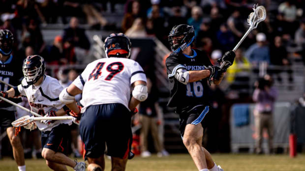Matt Collison takes a shot while John Schroter defends during the Virginia men's lacrosse game against Johns Hopkins at Klockner Stadium.