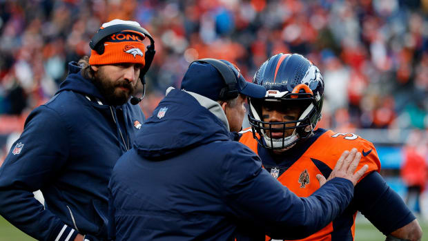 Oct 29, 2023; Denver, Colorado, USA; Denver Broncos head coach Sean Payton talks with quarterback Russell Wilson (3) and quarterbacks coach Davis Webb in the fourth quarter against the Kansas City Chiefs at Empower Field at Mile High. Mandatory Credit: Isaiah J. Downing-USA TODAY Sports