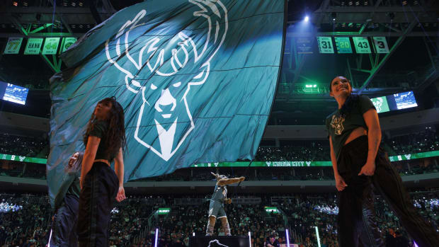  Milwaukee Bucks mascot Bango waves a flag with the Milwaukee Bucks logo 