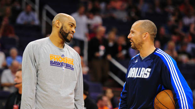 Dallas Mavericks guard Jason Kidd (right) talks with Phoenix Suns guard Vince Carter prior to the game at the US Airways Center