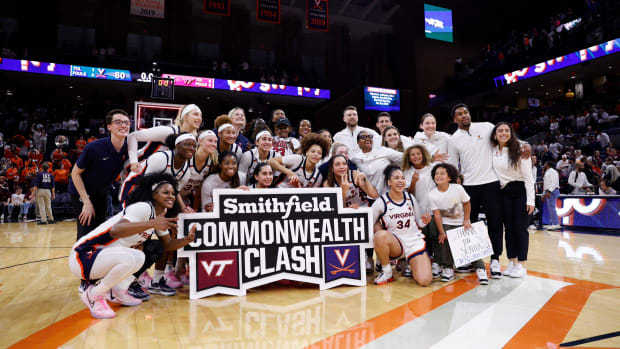 The Virginia women's basketball team celebrates after defeating Virginia Tech in the Commonwealth Clash at John Paul Jones Arena.