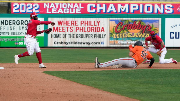 Mar 9, 2023; Clearwater, Florida, USA; Philadelphia Phillies second baseman Josh Harrison (2) turns a double play as Baltimore Orioles infielder Coby Mayo (95) slides under the throw and short stop Edmundo Sosa (33) looks on during the eighth inning at BayCare Ballpark. Mandatory Credit: Dave Nelson-USA TODAY Sports