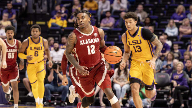 Feb 10, 2024; Baton Rouge, Louisiana, USA; Alabama Crimson Tide guard Latrell Wrightsell Jr. (12) brings the ball up court against LSU Tigers forward Jalen Reed (13) during the second half at Pete Maravich Assembly Center. Mandatory Credit: Stephen Lew-USA TODAY Sports