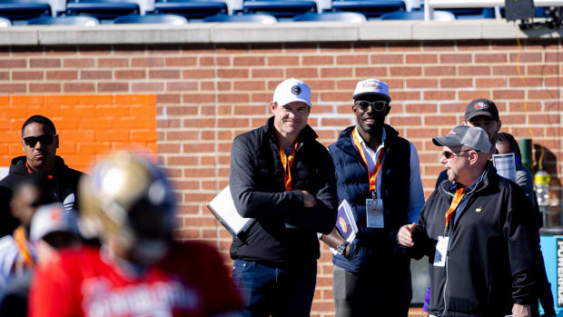 Kevin O'Connell and Kwesi Adofo-Mensah watch quarterback Michael Penix Jr. at the Senior Bowl in Mobile, Alabama.