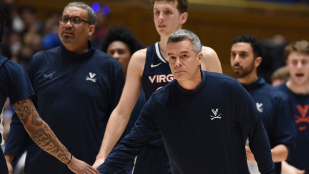 Virginia Cavaliers head coach Tony Bennett greets players during a timeout in the first half against the Duke Blue Devils at Cameron Indoor Stadium.