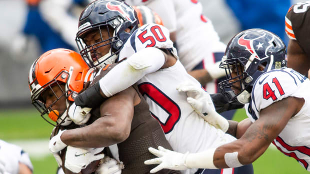 Nov 15, 2020; Cleveland, Ohio, USA; Houston Texans linebacker Tyrell Adams (50) tackles Cleveland Browns running back Kareem Hunt (27) during the second quarter at FirstEnergy Stadium. Mandatory Credit: Scott Galvin-USA TODAY Sports  