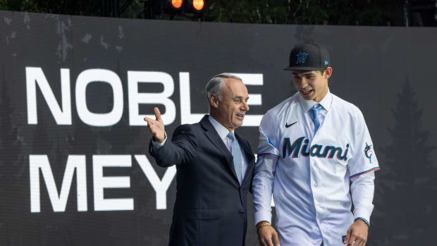 Jul 9, 2023; Seattle, Washington, USA; Miami Marlins draft pick Noble Meyer, right, is introduced by commissioner Rob Manfred during the first round of the MLB Draft at Lumen Field. Mandatory Credit: Stephen Brashear-USA TODAY Sports