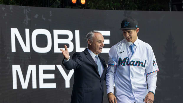 Jul 9, 2023; Seattle, Washington, USA; Miami Marlins draft pick Noble Meyer, right, is introduced by commissioner Rob Manfred during the first round of the MLB Draft at Lumen Field. Mandatory Credit: Stephen Brashear-USA TODAY Sports  