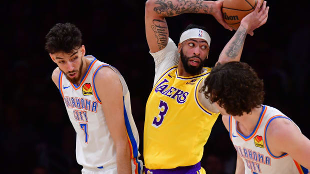 Mar 4, 2024; Los Angeles, California, USA; Los Angeles Lakers forward Anthony Davis (3) gets the rebound against Oklahoma City Thunder forward Chet Holmgren (7) during the first half at Crypto.com Arena. 