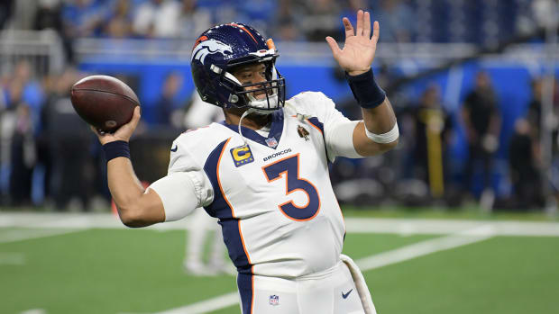 Denver Broncos quarterback Russell Wilson warms up before his team’s game in Detroit on Dec. 16, 2023.