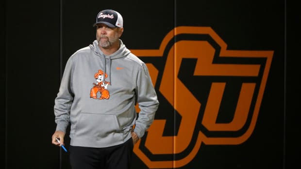 Oklahoma State coach Kenny Gajewski stands in the second softball game of a double header between the Oklahoma State University Cowgirls and the South Dakota State Jackrabbits, Tuesday, Feb. 27, 2024.