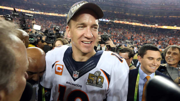 Peyton Manning smiles as he walks off the field of Super Bowl 50